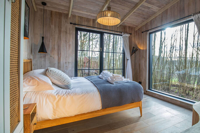 Double bed with surrounding windows