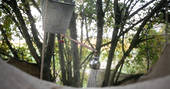 Bucket in a tree style shower on ground level at Puckshipton tree house in Wiltshire 